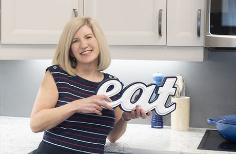 Learn Well - Michelle Holding a Carved Letter Sign Saying Eat